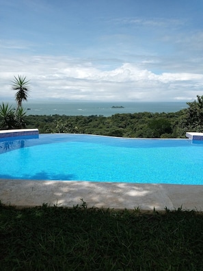 Outdoor pool, an infinity pool, pool umbrellas