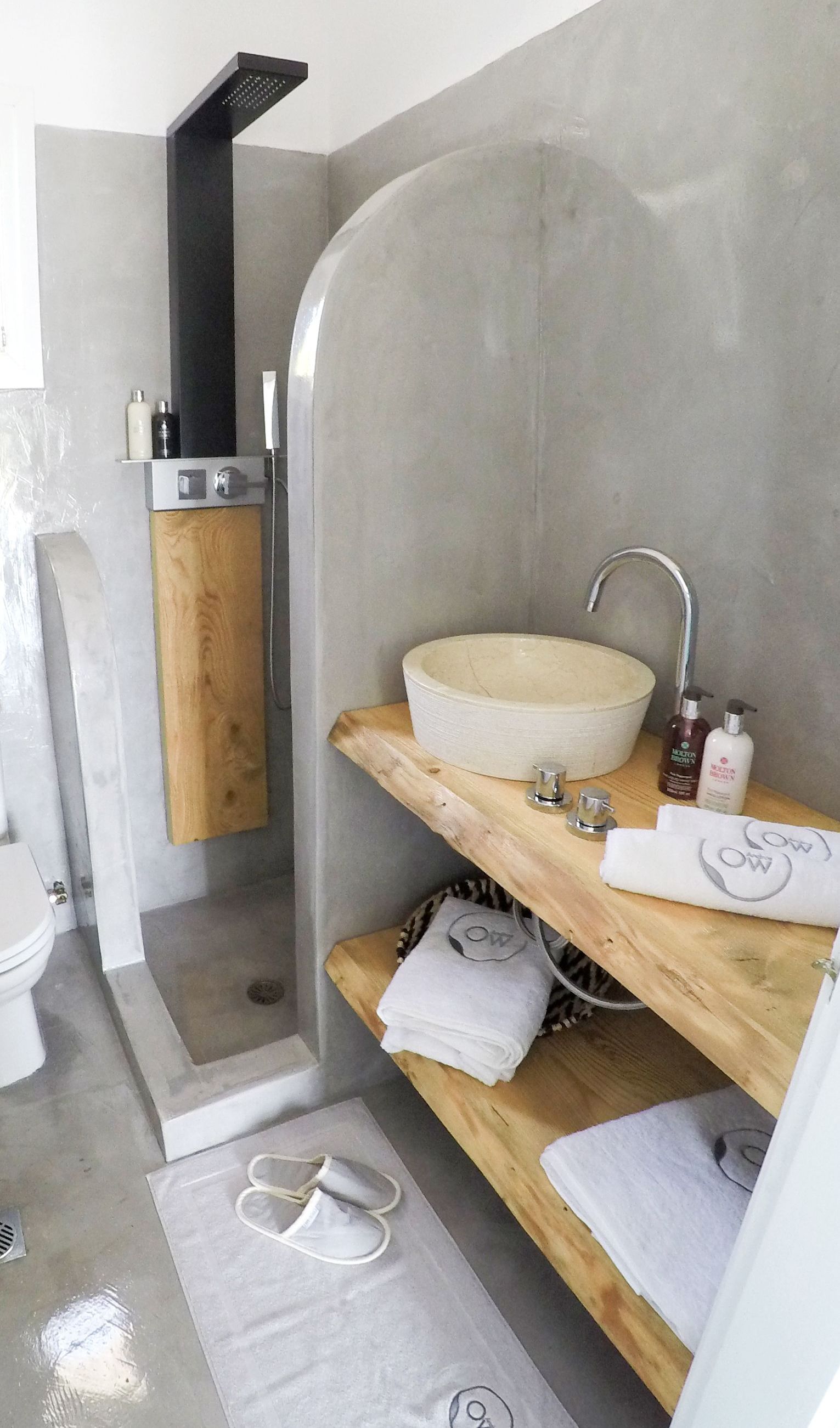 Un baño moderno con lavamanos integrado, ducha e inodoro.