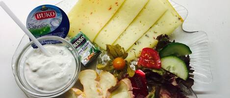A meal with cheese, salad, and a yogurt drink.