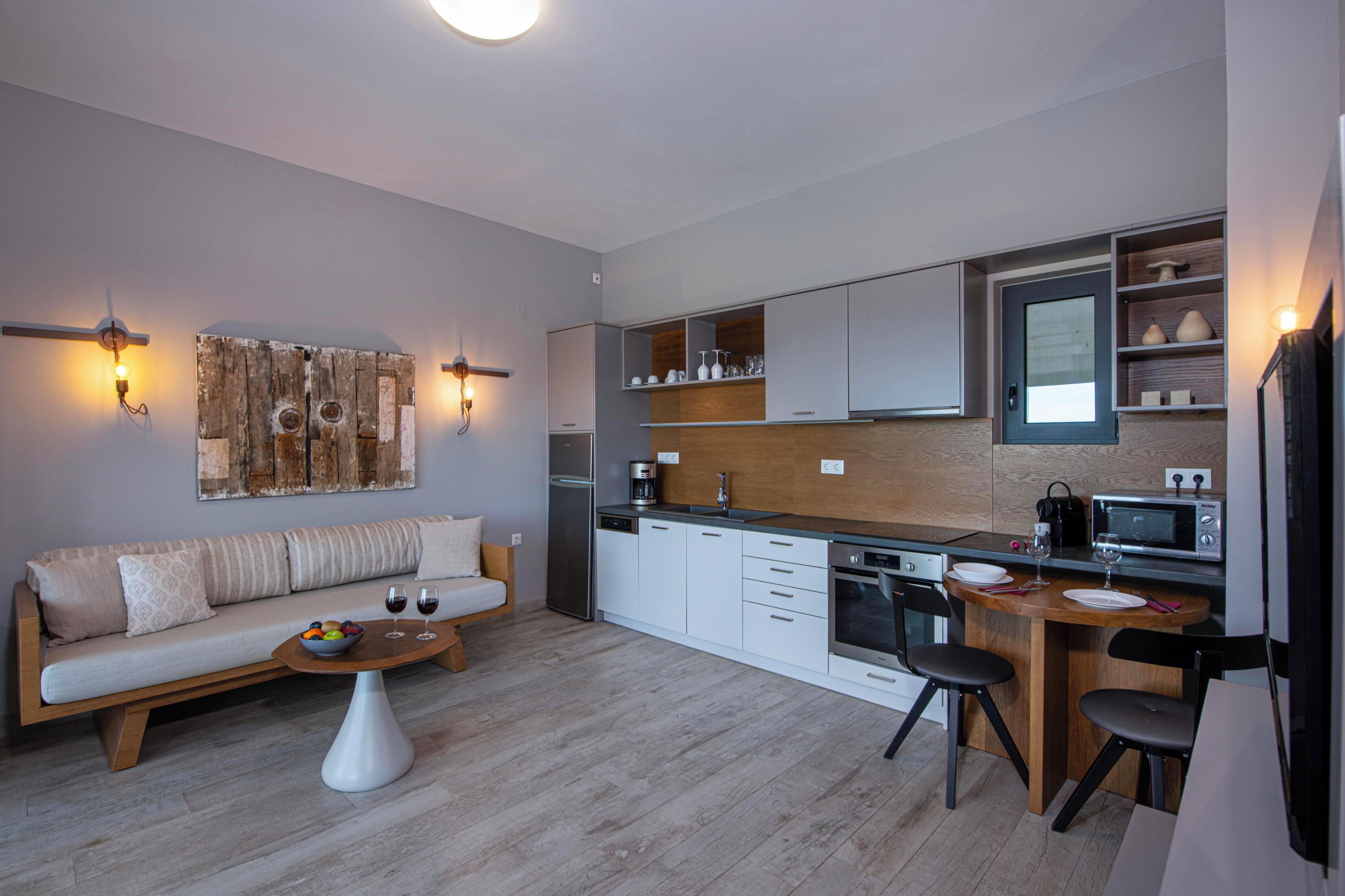 Eine moderne Küche mit weißen Schränken, einer Holz Arbeitsplatte und einer eingebauten Mikrowelle.