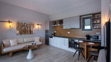 Eine moderne Küche mit weißen Schränken, einer Holz Arbeitsplatte und einer eingebauten Mikrowelle.