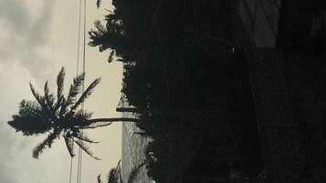 A building with a sloped roof and a visible power line.