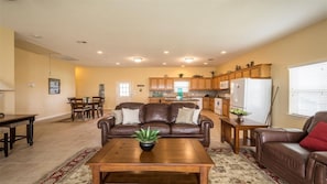 Relax in this inviting living space with a comfortable sofa, dining area, and fully equipped kitchen.