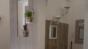 A bathroom with a wooden vanity, a sink, and a mirror.