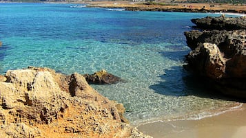 On the beach, sun loungers, beach towels