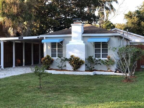 A house with a covered porch, a chimney, and a small tree in the front yard. - Weekends are best spent at the Beach! (Bradenton)