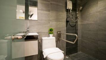 A modern bathroom with a toilet, sink, and shower.
