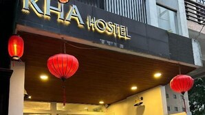 A hostel named "KHA HOSTEL" with a modern facade, red lanterns, and a welcoming entrance. - Kha Hotel - Hostel (Hue)
