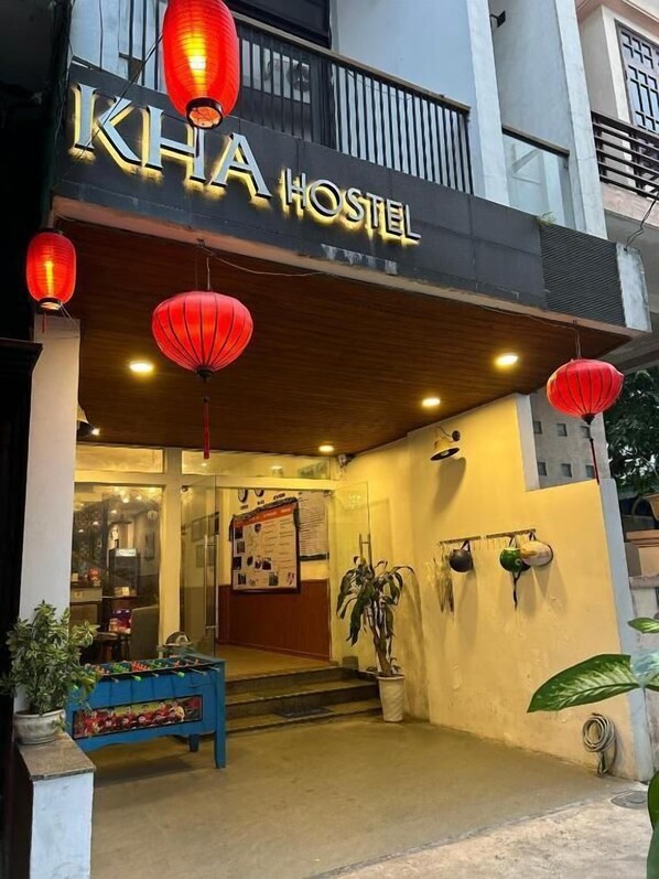 A hostel named "KHA HOSTEL" with a modern facade, red lanterns, and a welcoming entrance. - Kha Hotel - Hostel (Hue)