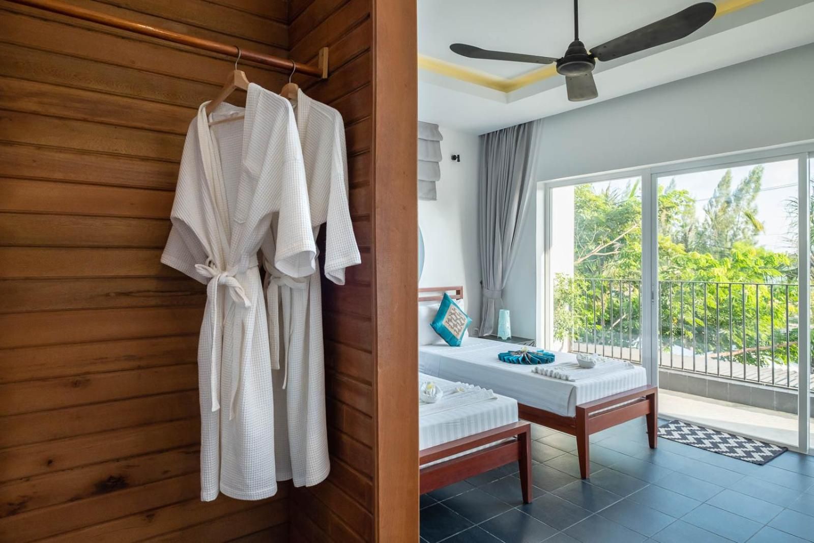 A wooden room with a bed and a balcony.