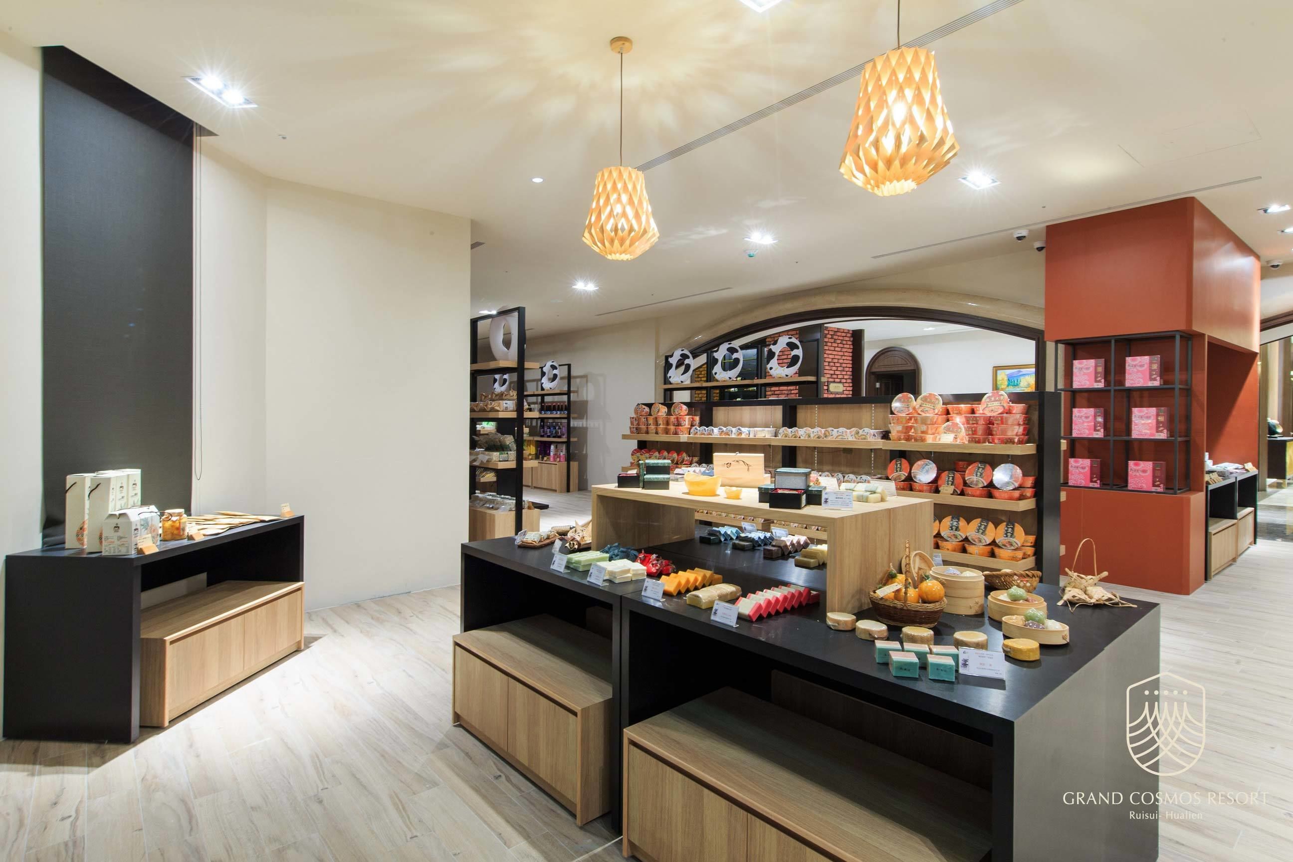 A modern retail space with wooden display counters, hanging lights, and various packaged goods.