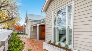 A house with a covered porch, a garage, and a brick pathway. - Grandview Accommodation - The Elm Tree Apartments (Mount Barker)