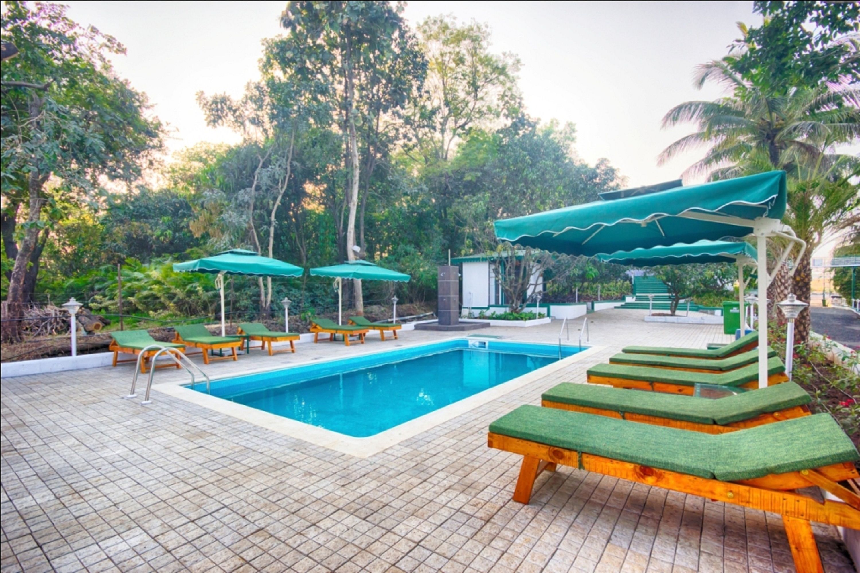 Outdoor pool, open 8:00 AM to 6:00 PM, pool umbrellas