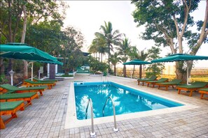 Outdoor pool, open 8:00 AM to 6:00 PM, pool umbrellas