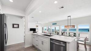 A modern kitchen with a large island, stainless steel appliances, and a view of the ocean. - 2 Beach Sets ☀️ Beachfront Ocean View | Private Beach | Direct Access ☀️ 118 10-Star Reviews (Santa Rosa Beach)