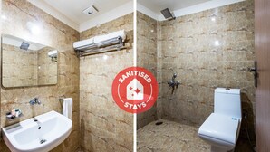 A bathroom with a sink, mirror, towel rack, and toilet. - OYO 11929 Hotel Ridhi Sidhi (Indore)