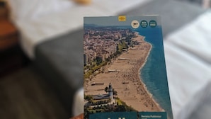 A person holding a travel guide for Calella.