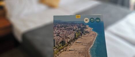 A person holding a travel guide for Calella.