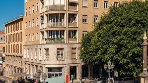 A multi-story hotel with balconies, a central courtyard, and a street view with cars and pedestrians. - Dome (Cagliari)