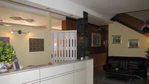 A modern living room with a sofa, a coffee table, and a decorative plant.
