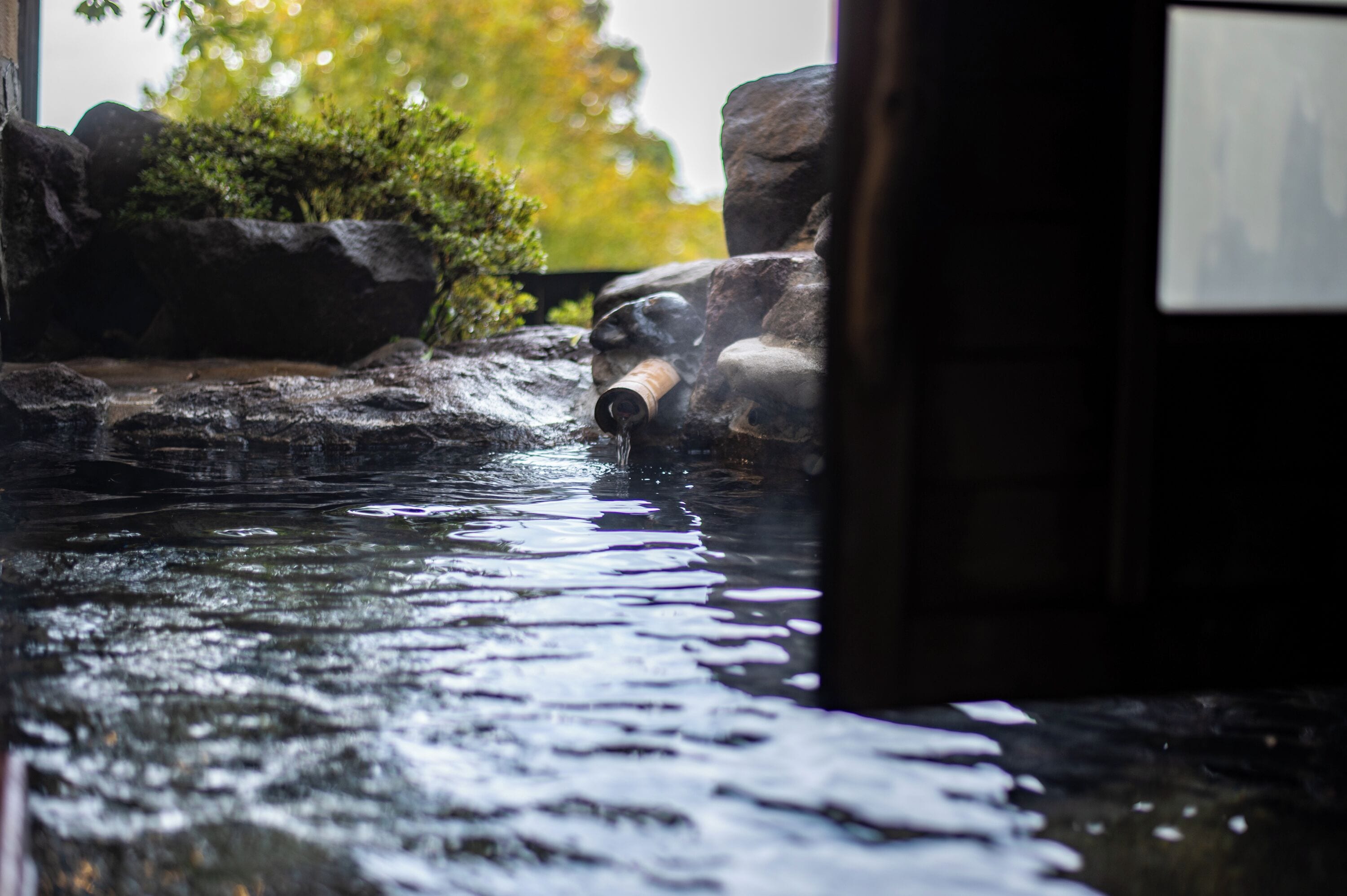 A water feature with rocks and a pipe, likely part of a garden or outdoor area.