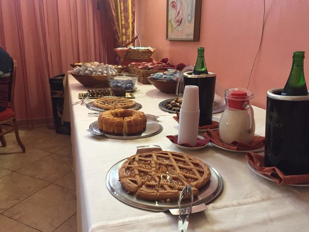 A buffet table with various food items, including a waffle, a cake, and a bottle of soda.