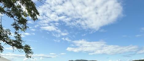 A wooden deck with a view of a lake and mountains.