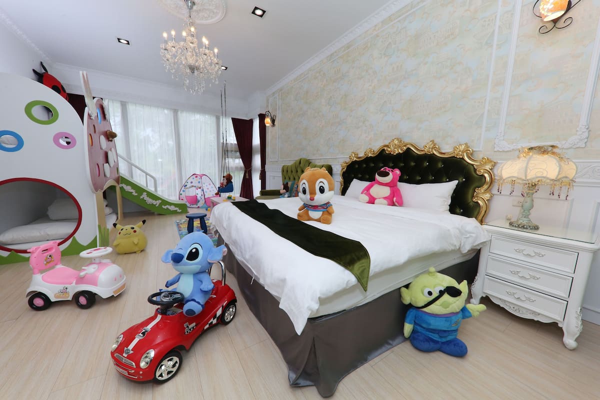 A child's bedroom with a bed, toys, and a play area.