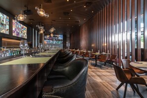 Enjoy a drink at the bar, where a long counter and stools invite conversation.