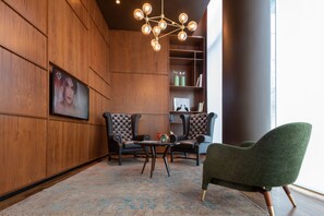 Relax in a cozy space with tufted leather armchairs and a comfortable seating area.