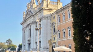 A large, historic building with classical architecture, including statues and columns. - Domus Romana B & B (Rome)