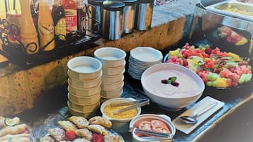 A buffet with various food items, condiments, and utensils.