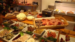 A buffet with various food items including meats, cheeses, and salads. - Overhalla Hotel (Overhalla)