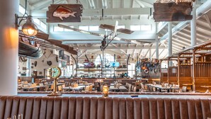 A spacious restaurant with high ceilings, wooden beams, and a central bar area. - Europa-Park Erlebnis-Resort, Hotel Krønasår (Rust)