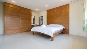 A spacious bedroom with a large bed, wooden wardrobe, and a bright, modern design. - Lemon House (Rawai)