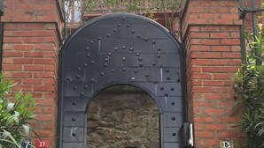 A traditional wooden building with a large arched entrance, a stone staircase leading up, and a sign reading "KOSKORMAN". - Kosk Orman Butik Otel (Adalar)