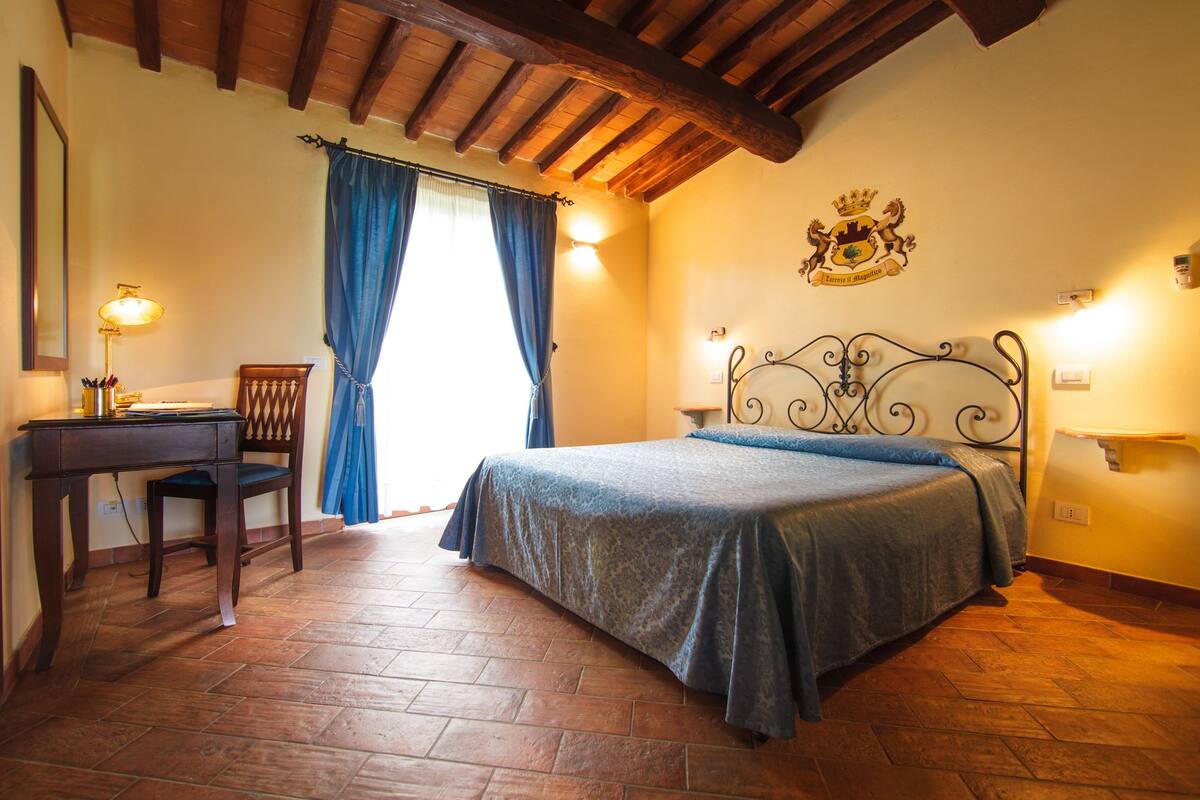 Ein Schlafzimmer mit Bett, Schreibtisch, Stuhl und einer Wanddekoration.