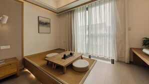 A modern, well-lit room with a wooden dining table, a cushioned bench, and a large window with sheer curtains. - Hangzhou West Lake Yueshang Yunshe Boutique Homestay (Hangzhou)
