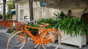 Una bicicleta estacionada frente a un edificio con un cartel que dice 'Hotel Olimpia'.