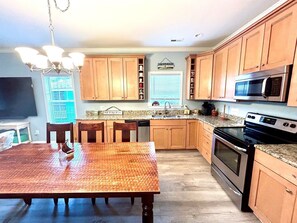 Enjoy cooking in this well-appointed kitchen with a dining table, sink, and microwave.