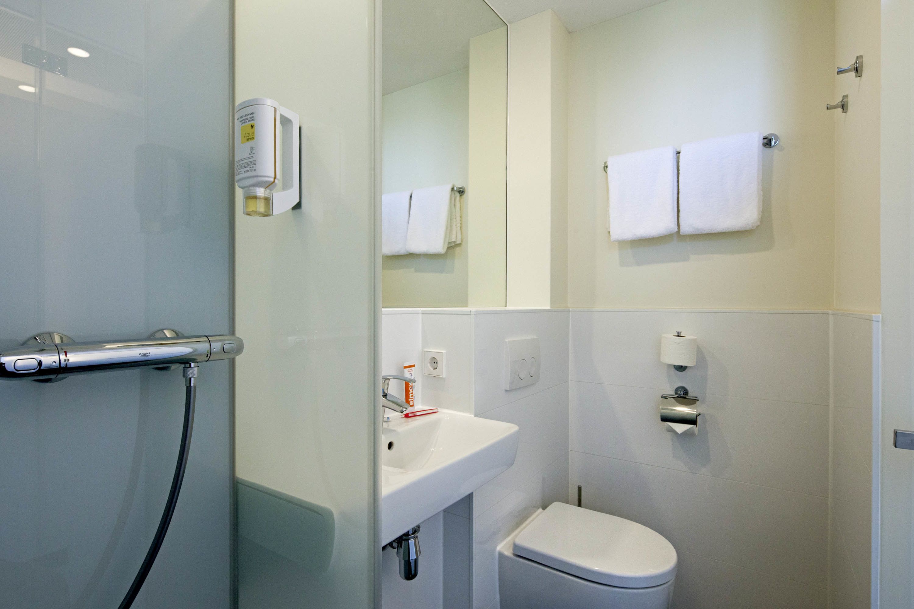 standard double room | bathroom | shower, eco-friendly toiletries, hair dryer, towels