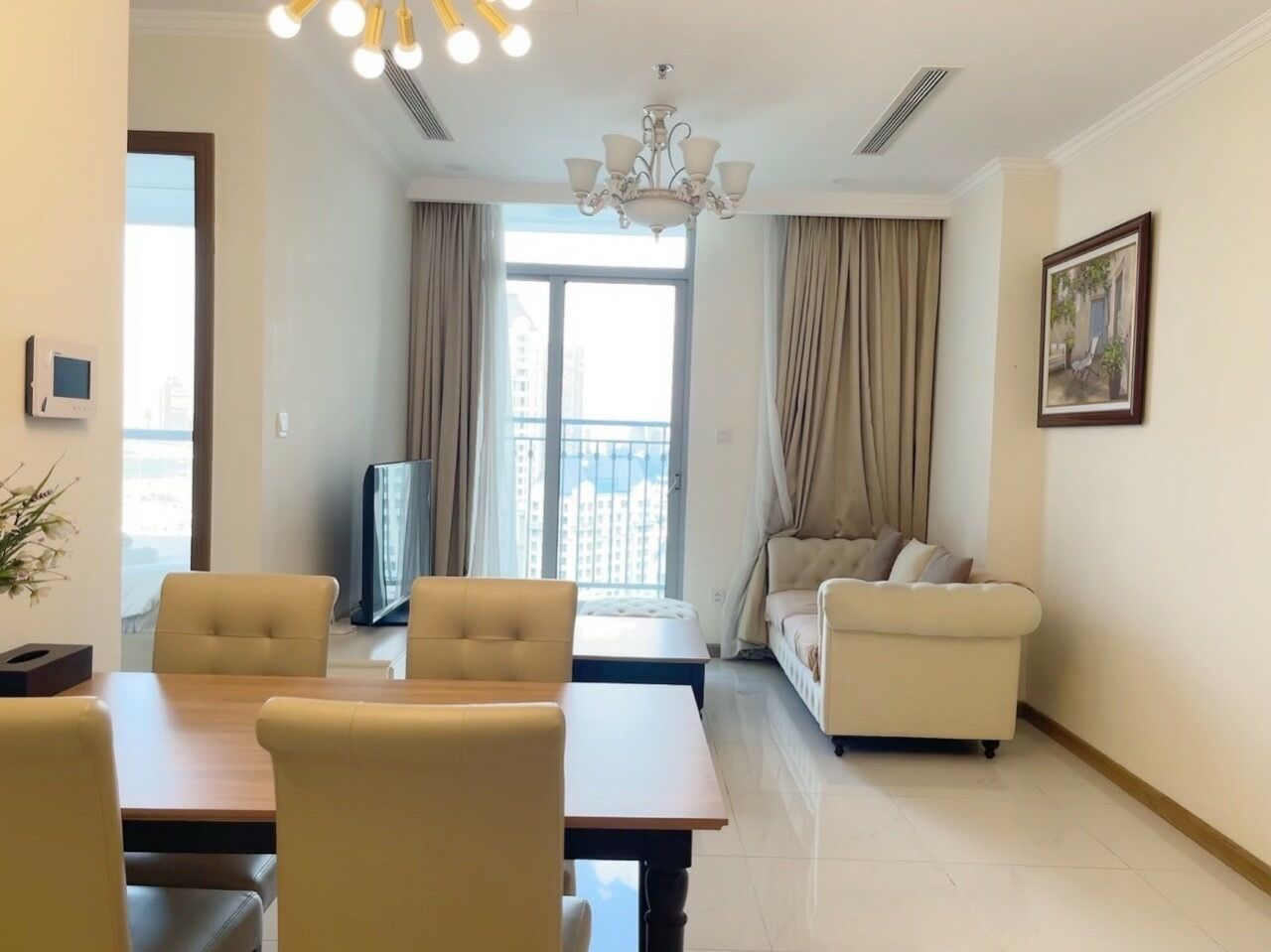 A modern living room with a dining area, a sofa, a TV, and a balcony with curtains.