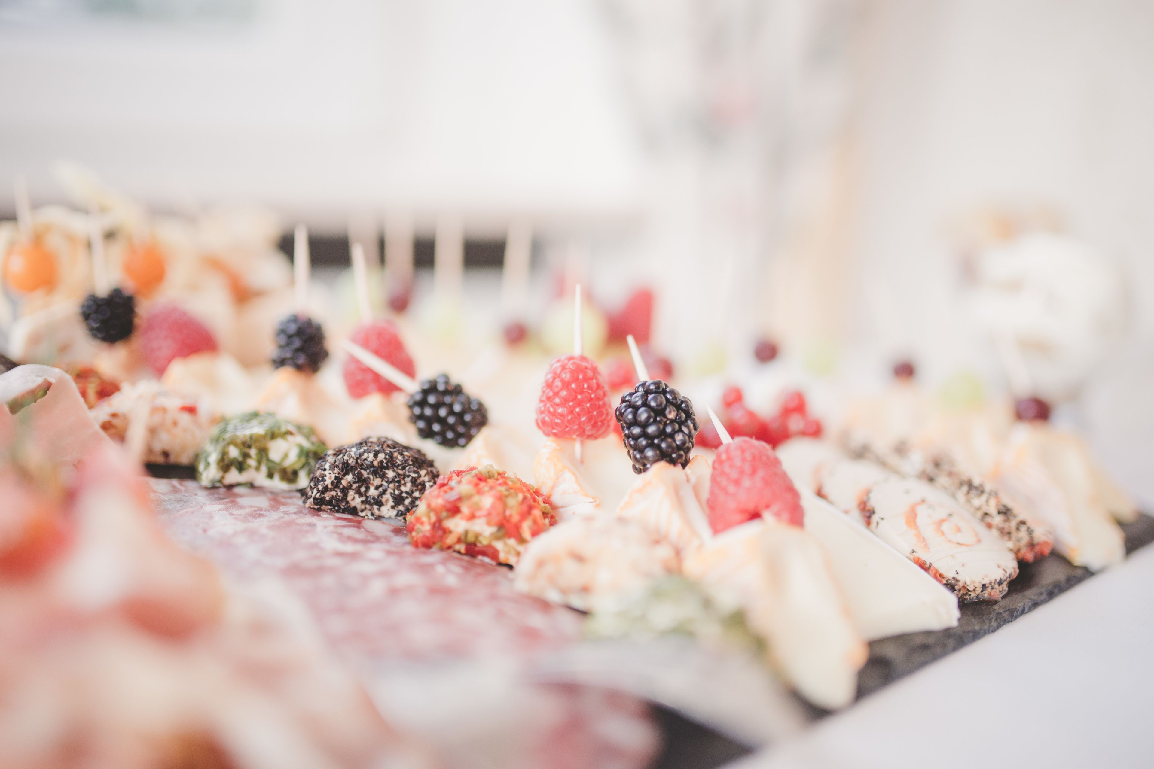 Une variété d’aliments sont disposés sur un plateau, notamment des fruits et des pâtisseries.