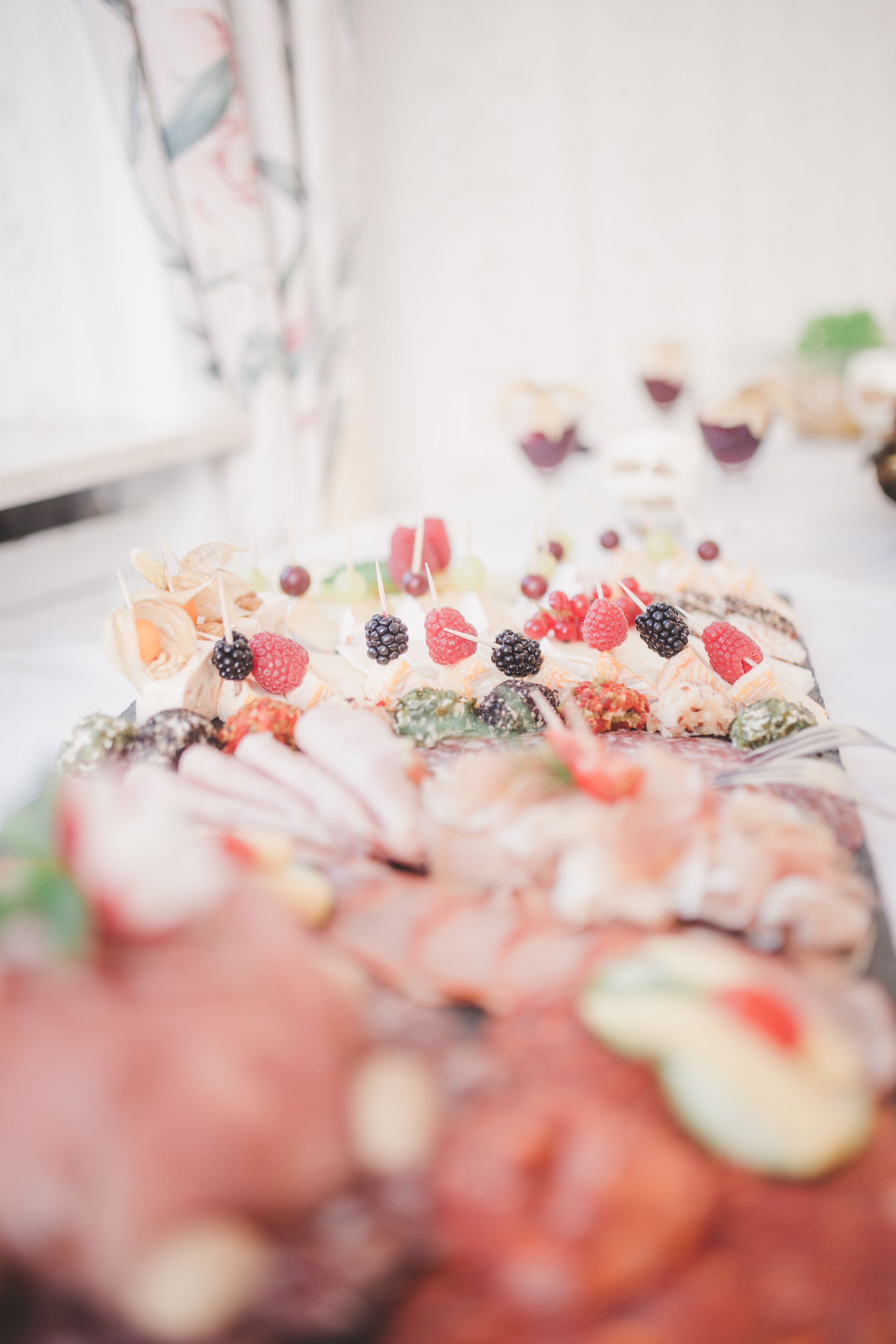A buffet with various food items including fruits and cheeses.