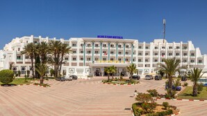 A large hotel with multiple floors, a central courtyard, and a parking area. - Palmyra Holiday Resort & Spa (Monastir)