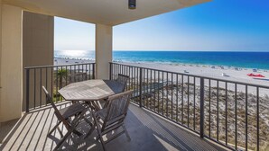 A balcony with a view of a beach and ocean. - See why our guests choose us! ~ Beach Front 2BR @ Phoenix IV #4044 (Orange Beach)