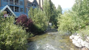 A building with multiple balconies and a clear view of a stream.