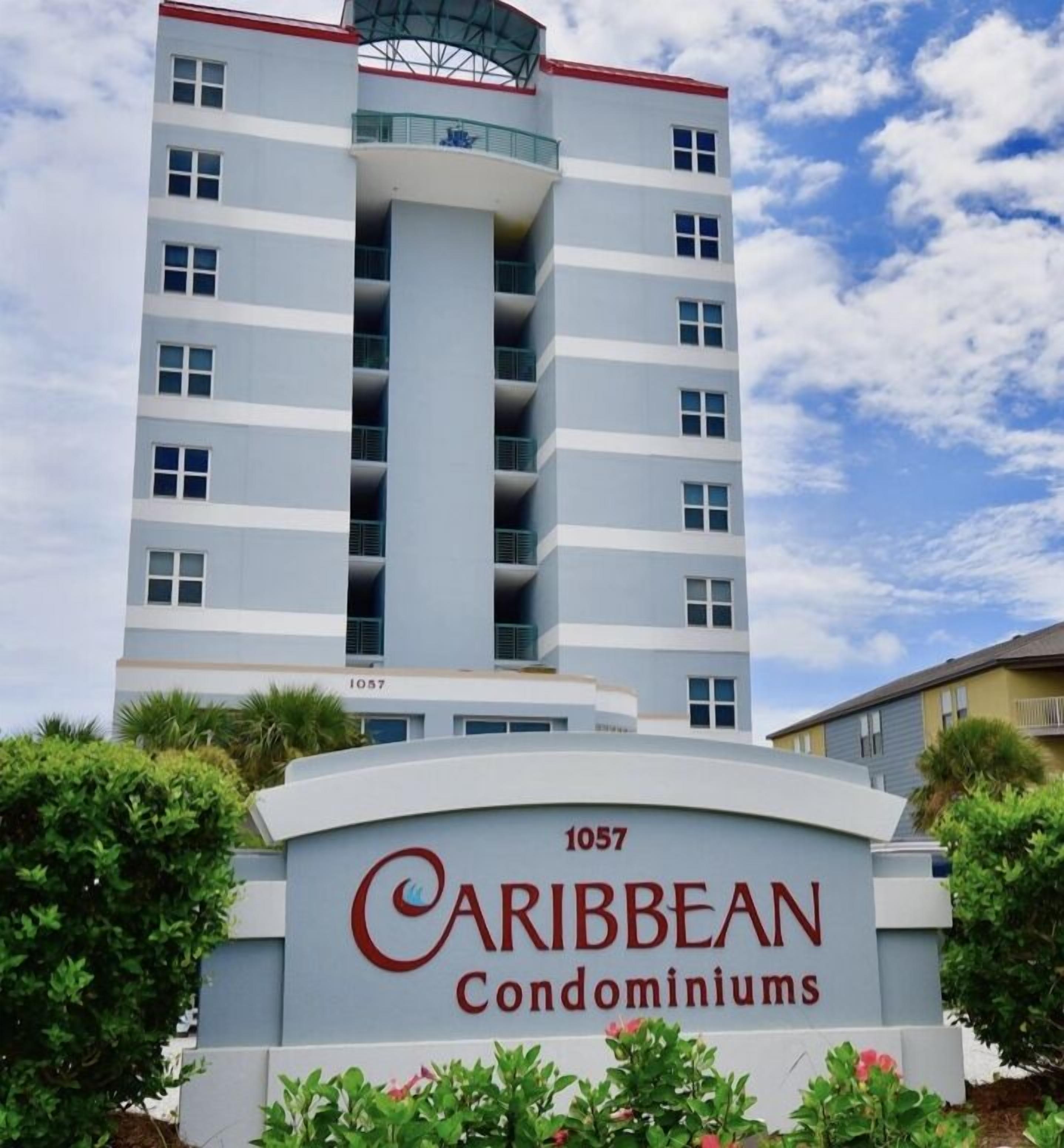 Un immeuble à plusieurs étages sur lequel on peut lire l’inscription : « 1057, résidences Caribbean ».