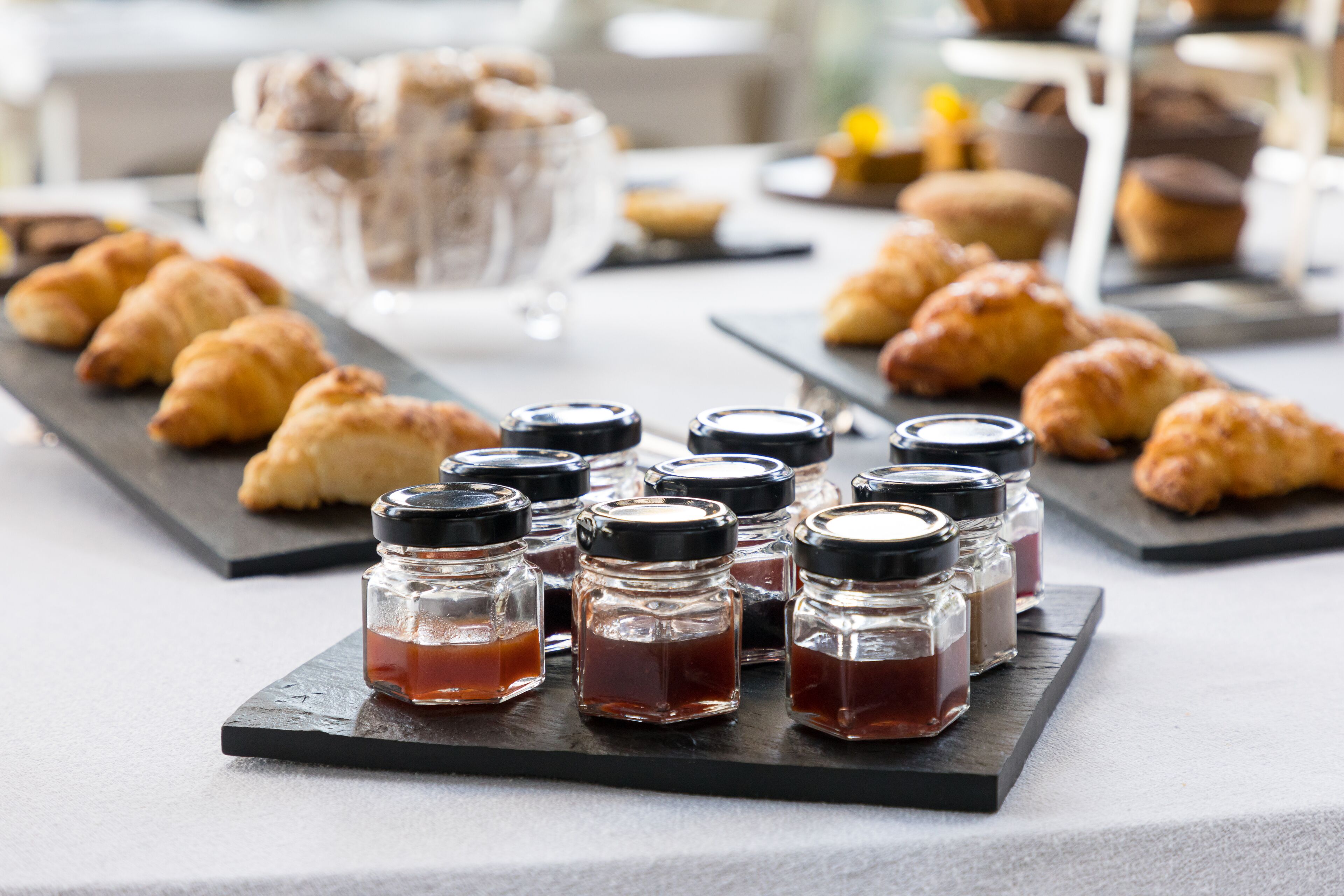 A table with pastries and condiments.