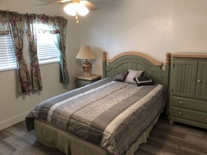 A bedroom with a bed, a nightstand, a lamp, and a wardrobe. - Welcome, enjoy your own PRIVATE POOL and LAKEFRONT Dock. Fish & Kayak (Lake Placid)